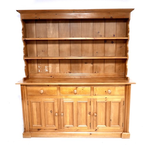 271 - A modern pine dresser, with plate rack over three drawers and three cupboards with turned knobs, 175... 