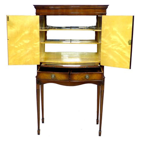 274 - A late 20th century cocktail cabinet, in George III style, with serpentine front, walnut veneers, tw... 