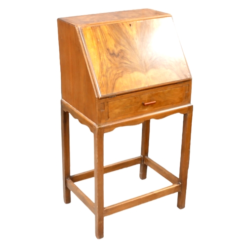 251 - An Art Deco walnut veneered student's desk, with fall front enclosing writing skivver and fitted int... 