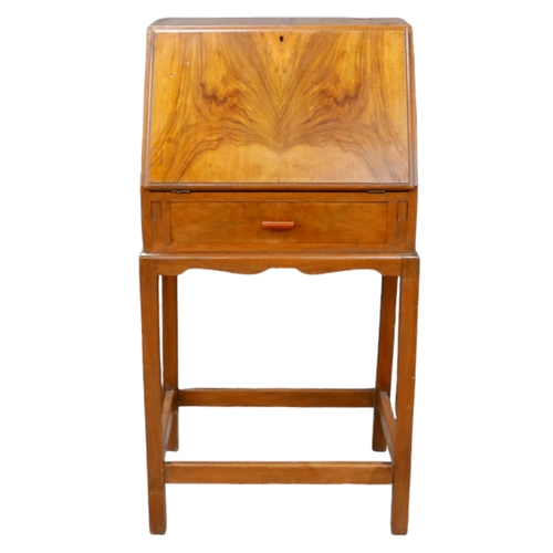 251 - An Art Deco walnut veneered student's desk, with fall front enclosing writing skivver and fitted int... 