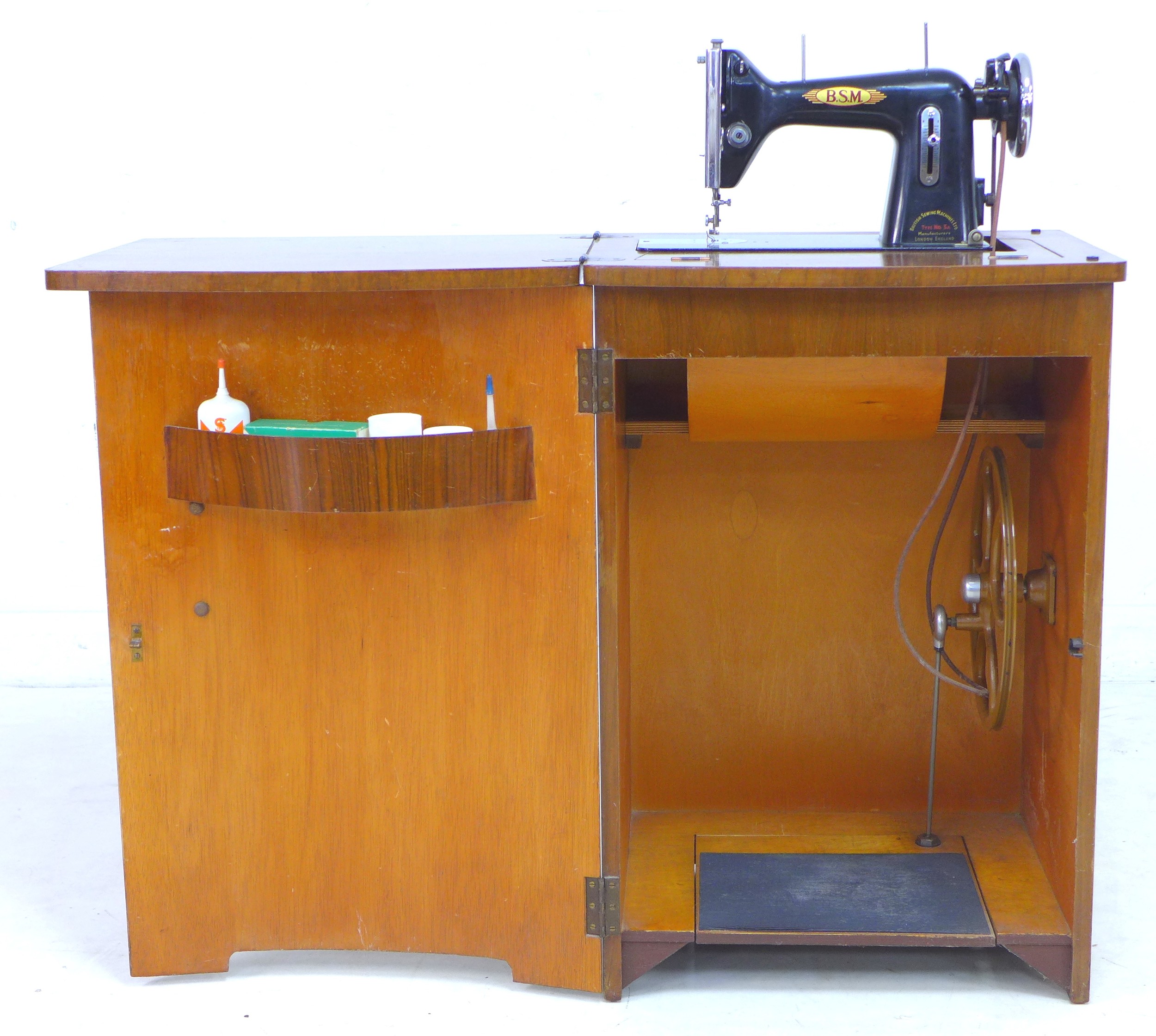 A vintage BSM (British Sewing Machines Ltd) treadle powered Type 3a sewing  machine, housed within a