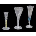 Three 20th century continental decorative wine glasses, all indistinctly signed, comprising an air t... 