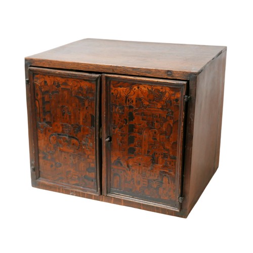 285 - A 18th century oak and fruitwood inlaid table top cabinet, the two doors intricately inlaid with a d... 