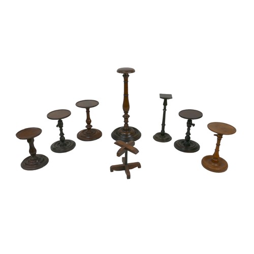 146 - A collection of wooden wig stands and candlestick holders, including a 19th century mahogany wig sta... 