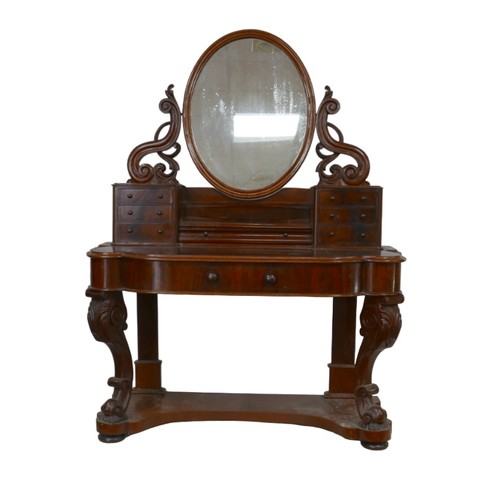 265 - A Victorian mahogany dressing table, its hinged oval mirror with shaped supports, two banks of six s... 