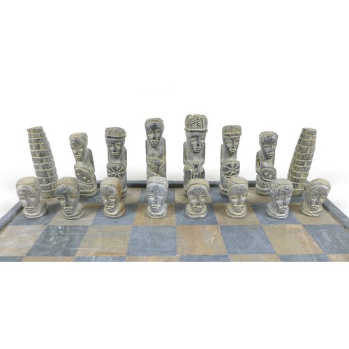 54 - An African soapstone chess set, board 36 by 36cm.