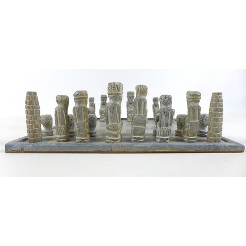 54 - An African soapstone chess set, board 36 by 36cm.