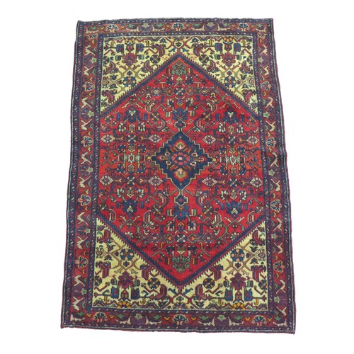 248 - A Hamadan rug, on red ground, densely decorated field with floral and foliate detail, blue diamond m... 