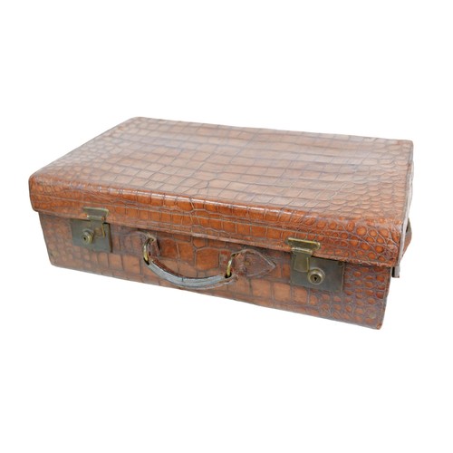133 - An early 20th century crocodile leather travel case, with fitted interior which is missing some of i... 