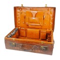 An early 20th century crocodile leather travel case, with fitted interior which is missing some of i... 
