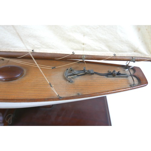 141 - A 19th/20th century scratch built sailing boat, with white painted hull, raised upon a rectangular p... 