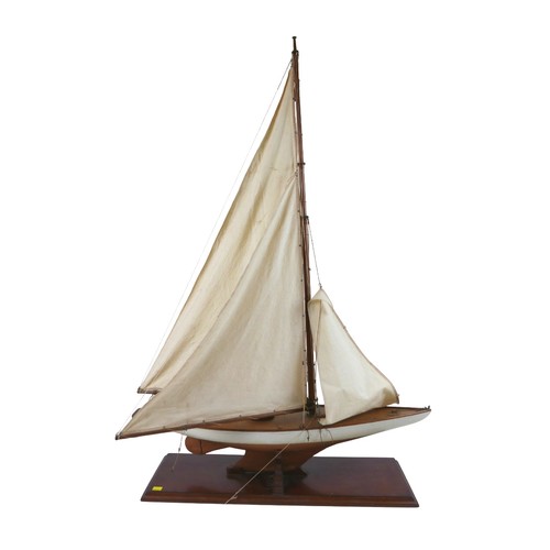141 - A 19th/20th century scratch built sailing boat, with white painted hull, raised upon a rectangular p... 