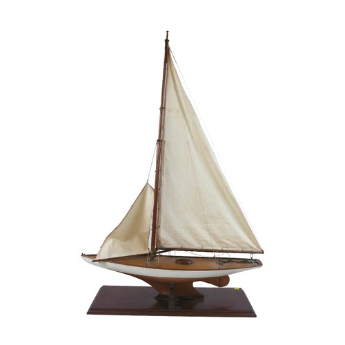 141 - A 19th/20th century scratch built sailing boat, with white painted hull, raised upon a rectangular p... 