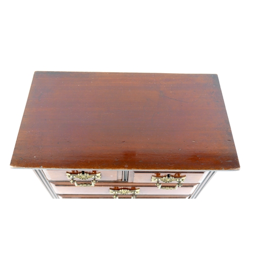 142 - A miniature Edwardian chest of drawers, brass handles, 32 by 18 by 34.5cm high.