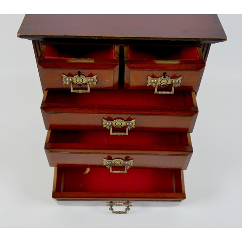 142 - A miniature Edwardian chest of drawers, brass handles, 32 by 18 by 34.5cm high.