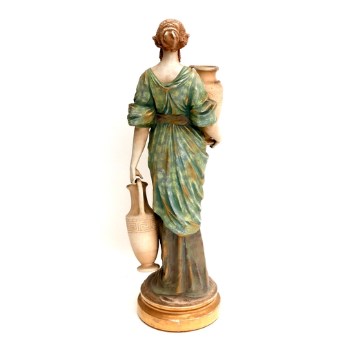24 - A large Austrian Amphora Pottery figure, modelled as a female water carrier, circa 1880's, decorated... 