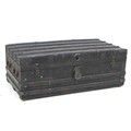 A late Victorian or Edwardian trunk, the wooden carcass bound in dark metal and wooden batons, with ... 