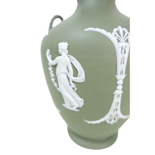 62 - A Wedgwood Jasperware dip green vase, of baluster form with twin handles, decorated with female figu... 