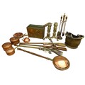 A collection of copper and brass, including a set of copper saucepans, a pair of fire dogs in the fo... 