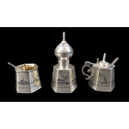 2 - An Egyptian white metal cruet, decorated with a signed design of a river Nile scene with boats, comp... 