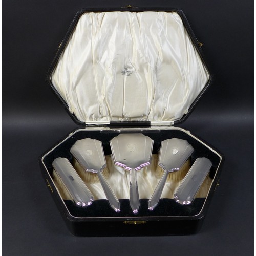 6 - A cased silver dressing table set, together with two napkin rings. (1 case)