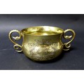 An Edwardian Britannia silver gilt twin handled bowl, with planished effect sides and snake form han... 