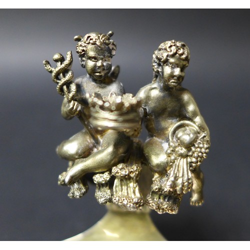 47 - A pair of ERII royal commemorative silver gilt salt dishes, with ornate handles incorporating cherub... 