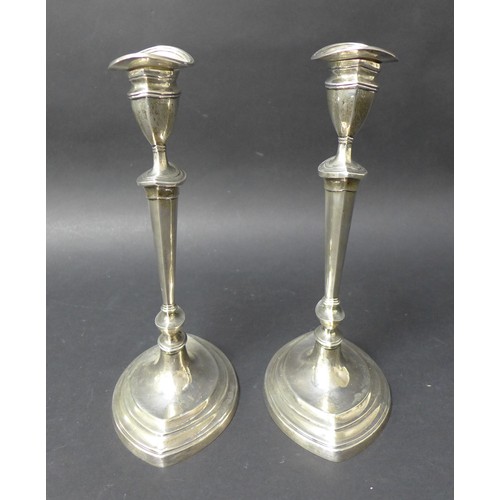 24 - A matched pair of George V silver candlesticks, with removable inserts and weighted bases, D & M Dav... 