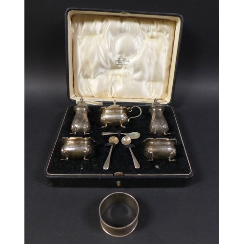 11 - An Edwardian silver five piece cruet set, Northern Goldsmiths Co, pepper 7.5cm high, one blue glass ... 