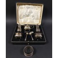 An Edwardian silver five piece cruet set, Northern Goldsmiths Co, pepper 7.5cm high, one blue glass ... 