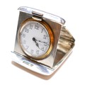 An Art Deco silver travel clock, with sprung fold out case, Swiss watch movement numbered 73637, cas... 
