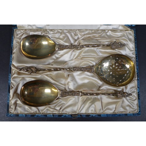 30 - A set of three silver gilt decorative serving spoons, with apostle finials and spiral stems, one wit... 