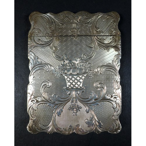 42 - An early Victorian silver card case, with scallop shaped outline, engraved C scroll, floral and foli... 