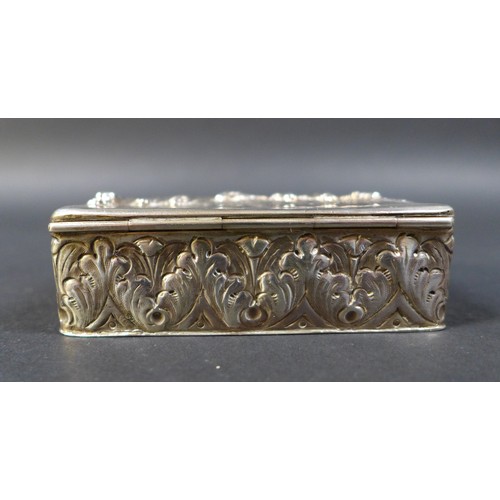 41 - A Victorian silver box, the hinged cover embossed with a village scene depicting five standing figur... 