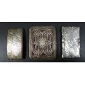 A group of three silver card cases, one curved with full width hinged tapering cover, engraved folia... 