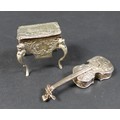 A late 19th century Hanau silver novelty box, in the form of a violin, with embossed decoration of m... 