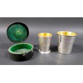 Two Victorian silver collapsible cups with gilt washed interiors, a three section cup, with armorial... 