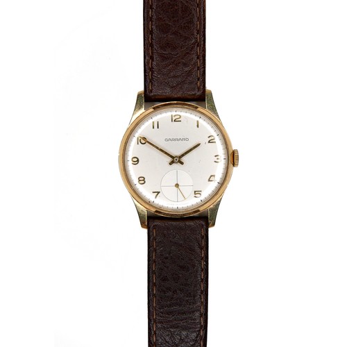 111 - A Garrard 9ct gold cased gentleman's wristwatch, on brown leather strap, presentation engraved verso... 