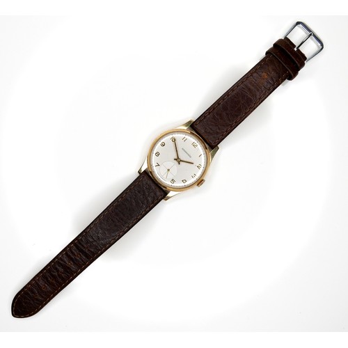 111 - A Garrard 9ct gold cased gentleman's wristwatch, on brown leather strap, presentation engraved verso... 