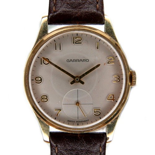 111 - A Garrard 9ct gold cased gentleman's wristwatch, on brown leather strap, presentation engraved verso... 