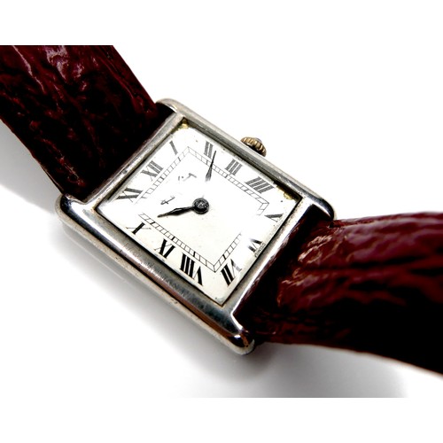 97 - A Roy King silver cased gentleman's wristwatch, with white square dial, on a red strap, 23.5mm case.