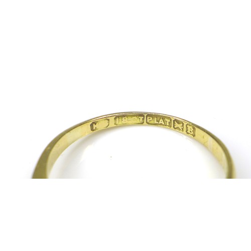 237 - An 18ct gold three stone diamond ring, size L, 2.2g, together with a 9ct gold crucifix, 4.1g. (2)