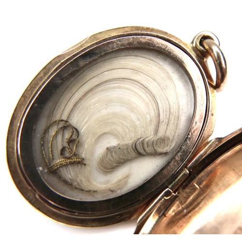 240 - A yellow metal and seed pearl Victorian mourning pendant, with a lock of hair enclosed, 12.8g.