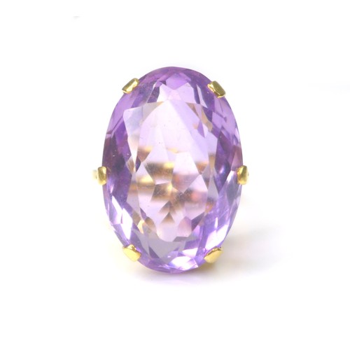 225 - An amethyst and yellow metal ring, the oval cut amethyst 15 by 22mm, ring size Q, 11.4g.