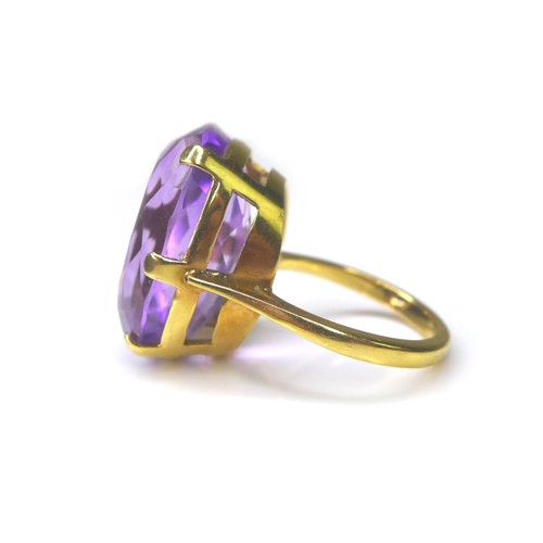 225 - An amethyst and yellow metal ring, the oval cut amethyst 15 by 22mm, ring size Q, 11.4g.