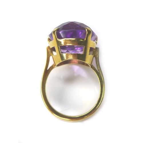 225 - An amethyst and yellow metal ring, the oval cut amethyst 15 by 22mm, ring size Q, 11.4g.