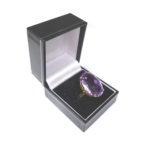 225 - An amethyst and yellow metal ring, the oval cut amethyst 15 by 22mm, ring size Q, 11.4g.