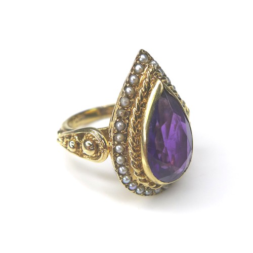 226 - An amethyst and seed pearl 9ct gold dress ring, pear cut amethyst 8 by 14mm, encircled by seed pearl... 