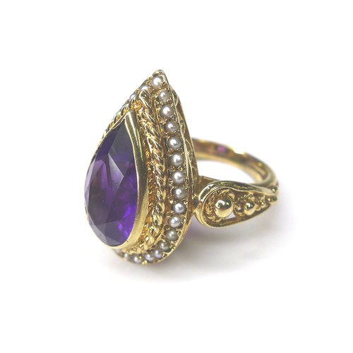 226 - An amethyst and seed pearl 9ct gold dress ring, pear cut amethyst 8 by 14mm, encircled by seed pearl... 