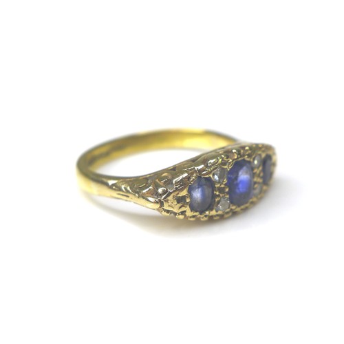 184 - A three stone blue sapphire and diamond ring, the central sapphire 3 by 5mm, four small round cut di... 